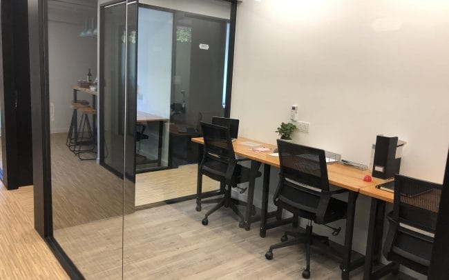 HK Works furnished 3-person office with large internal windows